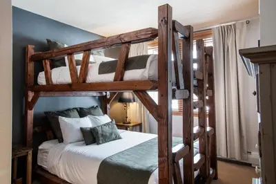 a bedroom with two bunk beds in a room at Cozy Lower Hughes View 2 BR Zephyr Mountain Lodge Condo with Ski Storage condo in Winter Park