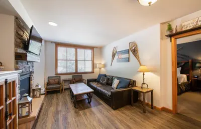 a living room with a couch and a fireplace at Cozy Lower Hughes View 2 BR Zephyr Mountain Lodge Condo with Ski Storage condo in Winter Park