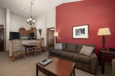 a living room with a couch and a table at Terrific Zephyr Mountain Lodge Condo With Beautiful Views of the Slopes condo in Winter Park