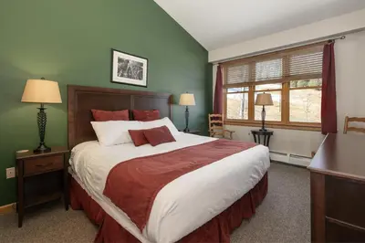 a bedroom with a large bed and a window at Terrific Zephyr Mountain Lodge Condo With Beautiful Views of the Slopes condo in Winter Park