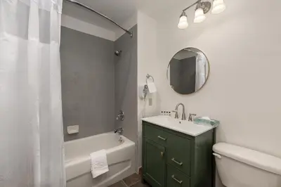 a bathroom with a sink and a tub and a mirror at Terrific Zephyr Mountain Lodge Condo With Beautiful Views of the Slopes condo in Winter Park