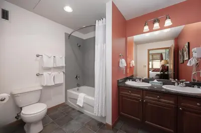 a bathroom with a toilet and a tub and a sink at Terrific Zephyr Mountain Lodge Condo With Beautiful Views of the Slopes condo in Winter Park