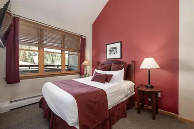 a bedroom with a large bed and a window at Terrific Zephyr Mountain Lodge Condo With Beautiful Views of the Slopes condo in Winter Park