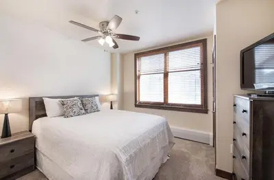 a bedroom with a bed and a ceiling fan at Spectacular Ski-In Ski-Out Zephyr Mountain Lodge Condo with Village Corridor View condo in Winter Park