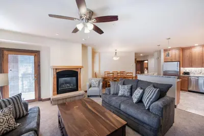 a living room with a couch and a fireplace at Spectacular Ski-In Ski-Out Zephyr Mountain Lodge Condo with Village Corridor View condo in Winter Park