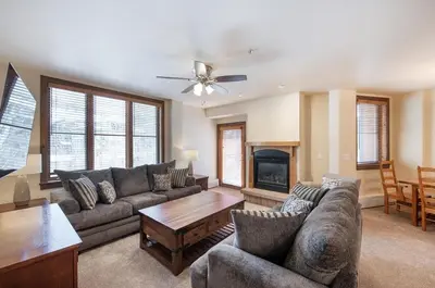a living room with a couch and a table at Spectacular Ski-In Ski-Out Zephyr Mountain Lodge Condo with Village Corridor View condo in Winter Park