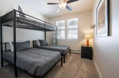 a bedroom with two bunk beds and a ceiling fan at Winter Park FF Select Rated Condo 4654 in Winter Park