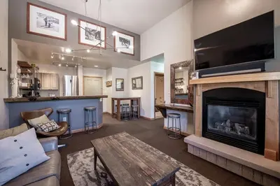 a living room with a fireplace and a tv at Lovely Mountain Adventure Zephyr Mountain Lodge Condo with Ski Storage condo in Winter Park