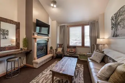 a living room with a couch and a fireplace at Lovely Mountain Adventure Zephyr Mountain Lodge Condo with Ski Storage condo in Winter Park