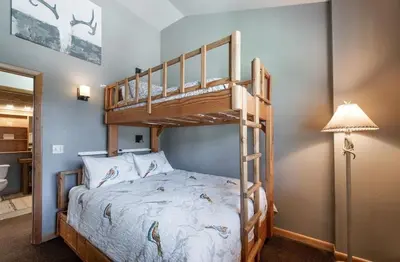 a bedroom with a bunk bed with a ladder at Lovely Mountain Adventure Zephyr Mountain Lodge Condo with Ski Storage condo in Winter Park