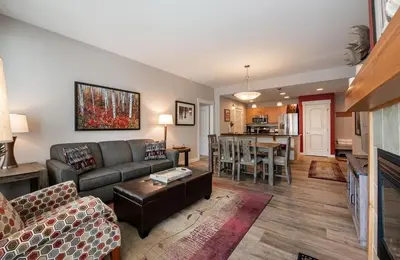a living room with a couch and a dining room at Beautiful Ski-In Ski-Out Condo at Fraser Crossing Founders Pointe condo in Winter Park
