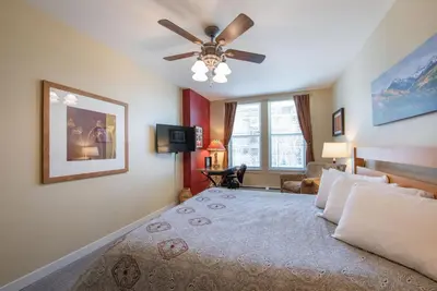 a bedroom with a bed and a ceiling fan at Beautiful Ski-In Ski-Out Condo at Fraser Crossing Founders Pointe condo in Winter Park