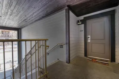 a hallway with a door and a stair case at Beautiful Ski-In Ski-Out Condo at Fraser Crossing Founders Pointe condo in Winter Park