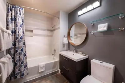 a bathroom with a sink and a toilet and a mirror at Beautiful Zephyr Mountain Lodge Condo with wine coole! - Close to Gondola! condo in Winter Park