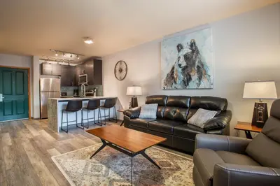 a living room with a couch and a table at Beautiful Zephyr Mountain Lodge Condo with wine coole! - Close to Gondola! condo in Winter Park