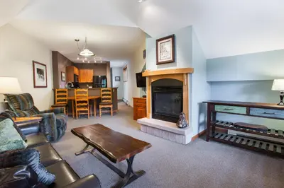 a living room with a couch and a fireplace at Unique & Comfortable Zephyr Mountain Lodge Condo with Slope and Continental Divide View condo in Winter Park