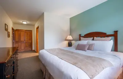 a bedroom with a large white bed and a desk at Unique & Comfortable Zephyr Mountain Lodge Condo with Slope and Continental Divide View condo in Winter Park
