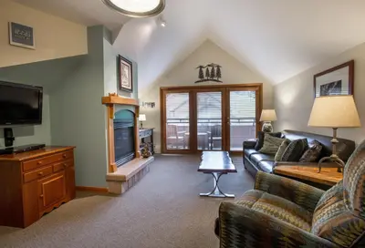 a living room with a couch and a tv at Unique & Comfortable Zephyr Mountain Lodge Condo with Slope and Continental Divide View condo in Winter Park
