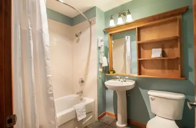 a bathroom with a sink and a toilet and a bath tub at Unique & Comfortable Zephyr Mountain Lodge Condo with Slope and Continental Divide View condo in Winter Park