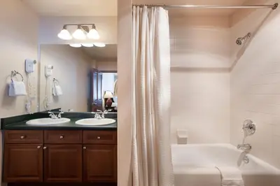 a bathroom with two sinks and a tub and a shower at Zephyr Mountain Lodge Condo with views of Arapahoe National Forest condo in Winter Park