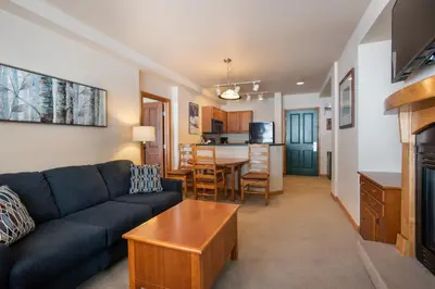 a living room with a couch and a table at Zephyr Mountain Lodge Condo with views of Arapahoe National Forest condo in Winter Park