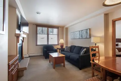 a living room with a couch and a table at Zephyr Mountain Lodge Condo with views of Arapahoe National Forest condo in Winter Park