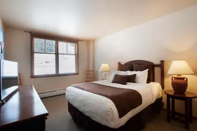 a bedroom with a large bed and a window at Zephyr Mountain Lodge Condo with views of Arapahoe National Forest condo in Winter Park