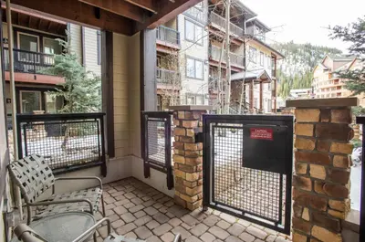 a balcony with a gate and chairs on a building at Beautiful Fraser Crossing Founders Pointe Condo with Upgraded Furnishings condo in Winter Park