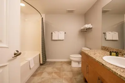 a bathroom with a sink and a toilet and a tub at Beautiful Fraser Crossing Founders Pointe Condo with Upgraded Furnishings condo in Winter Park