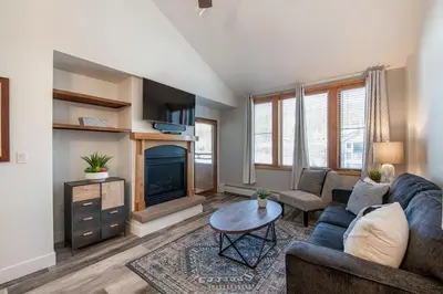a living room with a couch and a fireplace at Comfortable Zephyr Mountain Lodge Condo with Spectacular View of the Continental Divide condo in Winter Park
