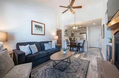 a living room with a couch and a table at Comfortable Zephyr Mountain Lodge Condo with Spectacular View of the Continental Divide condo in Winter Park