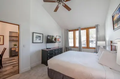 a bedroom with a bed and a ceiling fan at Comfortable Zephyr Mountain Lodge Condo with Spectacular View of the Continental Divide condo in Winter Park