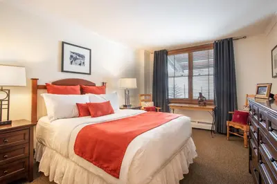 a bedroom with a bed and a desk and a window at Gorgeous Zephyr Mountain Lodge Condo with Corridor Ski Trail Views condo in Winter Park