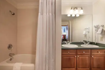 a bathroom with two sinks and a tub and a shower at Gorgeous Zephyr Mountain Lodge Condo with Corridor Ski Trail Views condo in Winter Park