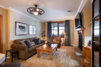 a living room with a couch and a coffee table at Gorgeous Zephyr Mountain Lodge Condo with Corridor Ski Trail Views condo in Winter Park