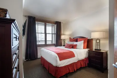 a bedroom with a large bed and a window at Gorgeous Zephyr Mountain Lodge Condo with Corridor Ski Trail Views condo in Winter Park