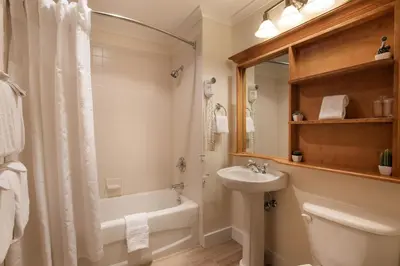 a bathroom with a tub and a sink and a toilet at Gorgeous Zephyr Mountain Lodge Condo with Corridor Ski Trail Views condo in Winter Park