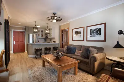 a living room with a couch and a table at Gorgeous Zephyr Mountain Lodge Condo with Corridor Ski Trail Views condo in Winter Park