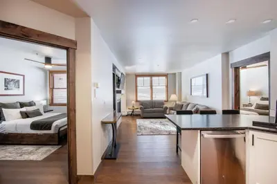 a kitchen and living room with a bed and a living room at Warm & Cozy Zephyr Mountain Lodge condo with Arapahoe Forest and Corridor Ski Trail Views condo in Winter Park
