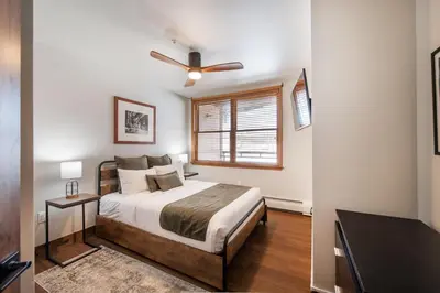 a bedroom with a bed and a ceiling fan at Warm & Cozy Zephyr Mountain Lodge condo with Arapahoe Forest and Corridor Ski Trail Views condo in Winter Park
