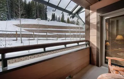 a balcony with a view of a snow covered field at Warm & Cozy Zephyr Mountain Lodge condo with Arapahoe Forest and Corridor Ski Trail Views condo in Winter Park