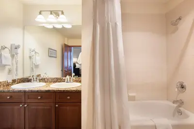 a bathroom with two sinks and a tub and a shower at Great Ski-In Ski-Out Zephyr Mountain Lodge Condo with Lovely Balcony Views condo in Winter Park