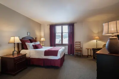 a hotel room with a bed and a window at Great Ski-In Ski-Out Zephyr Mountain Lodge Condo with Lovely Balcony Views condo in Winter Park