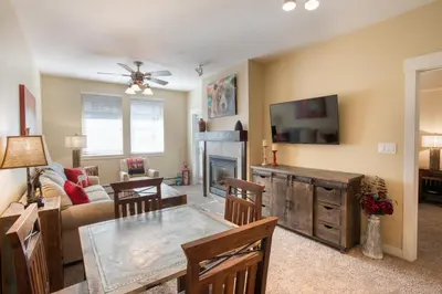 a living room with a table and a fireplace at Charming Fraser Crossing Founders Pointe condo with Easy Gondola Access condo in Winter Park