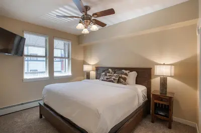 a bedroom with a bed and a ceiling fan at Charming Fraser Crossing Founders Pointe condo with Easy Gondola Access condo in Winter Park