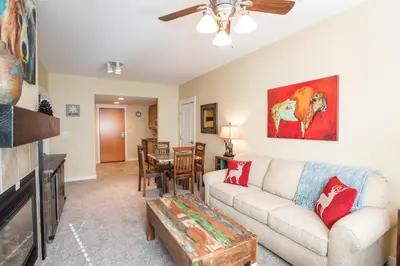a living room with a couch and a table at Charming Fraser Crossing Founders Pointe condo with Easy Gondola Access condo in Winter Park