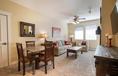 a living room with a table and a couch at Charming Fraser Crossing Founders Pointe condo with Easy Gondola Access condo in Winter Park