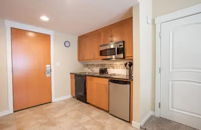 a kitchen with a stove and a microwave at Charming Fraser Crossing Founders Pointe condo with Easy Gondola Access condo in Winter Park