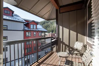 a balcony with a chair and a building at Charming Fraser Crossing Founders Pointe condo with Easy Gondola Access condo in Winter Park