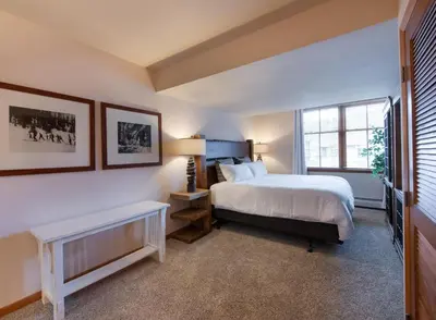 a bedroom with a bed and a window at Lovely Zephyr Mountain Lodge Condo with Cozy Alcove - Close to Mountain condo in Winter Park